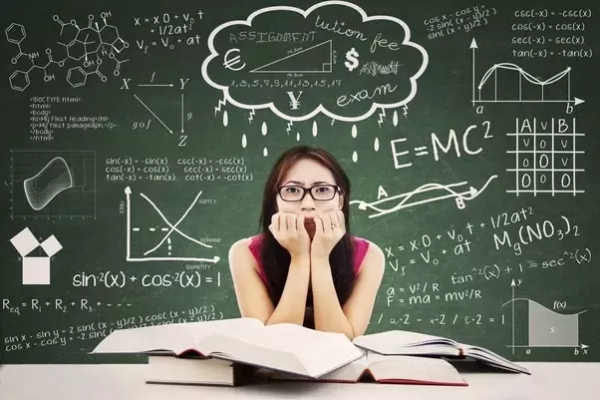 Portrait of student looking scared to face exam while studying with textbooks