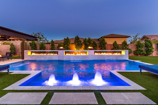 Swimming pool with decorative led lights and brick wall