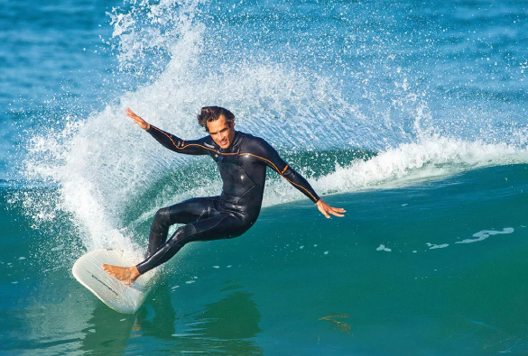 A Man Enjoying Skating In The Beach