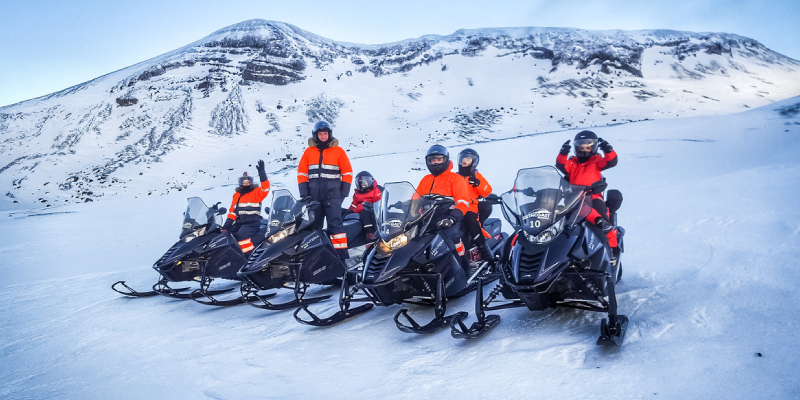 A Group Of Friends Get Ready FFor Snowmobiling.
