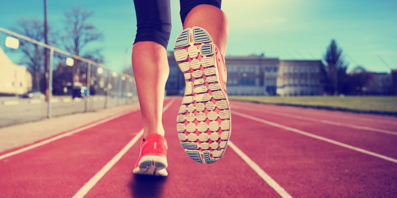 A Close-up View Of A Man's Boots During His Jogging On A Sunny Day.