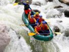 Group of Young People Enjoying While In River Rafting.