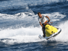 Man Having Fun With Water Scooter In The Beach.