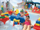 Group of Kids Playing With Water Toys.