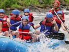 Group of Happy People While In River Rafting.