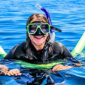 A Woman Wearing Swim Suit And Goggles For Scuba Diving.