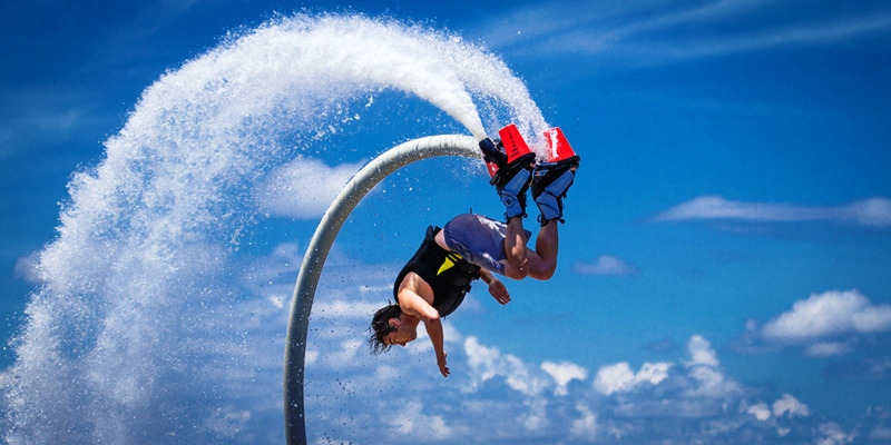 An Image Representing Flyboarding of A man.