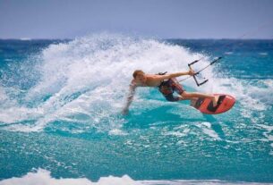 A man Enjoying Skateboarding In The Sea.