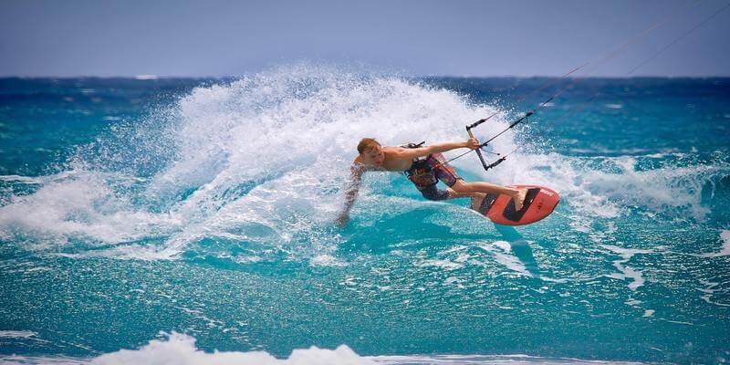 A man Enjoying Skateboarding In The Sea.