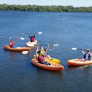 An Image of Multiple Boats With People - Kayaking Concept.